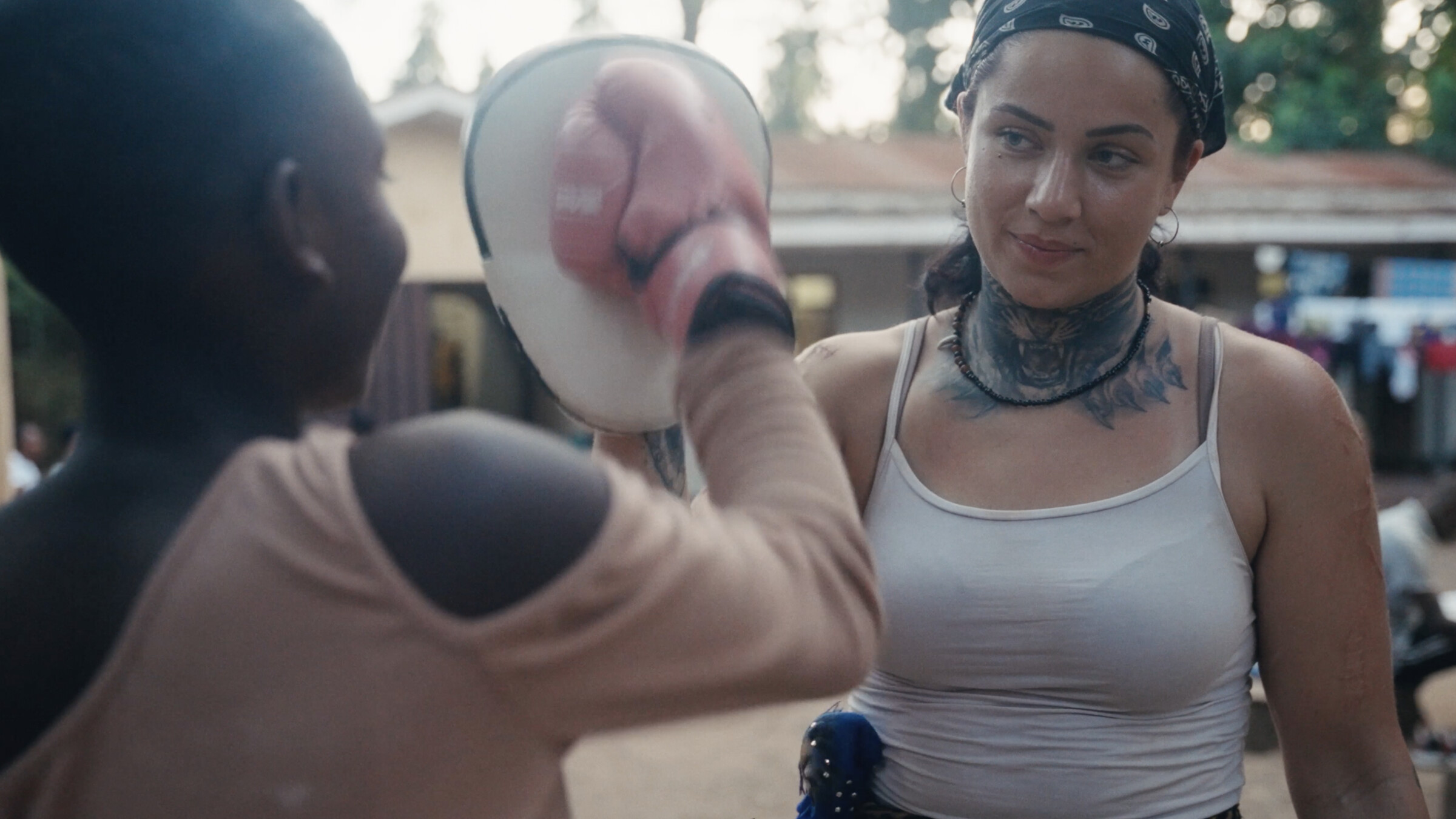 Julija Pajic training with a young fighter in Tanzania — official film still